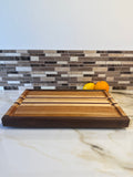 Heritage Cutting Board 18” × 12” × 1.5” — Maple, Walnut, Cherry & Purple Heart | Juice Groove + Hand Holds with brass feet