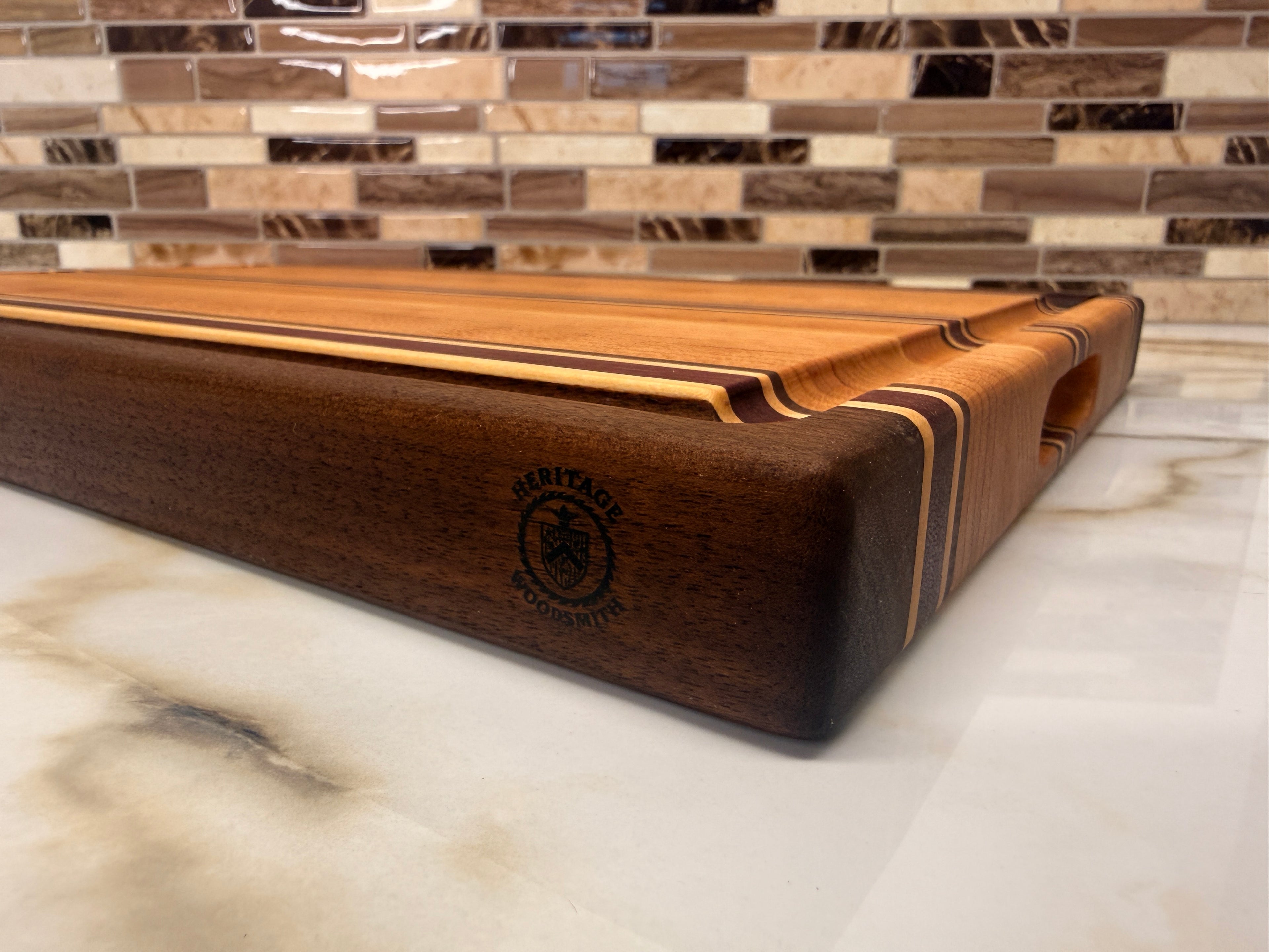 Heritage Cutting Board 18” × 12” × 1.5” — Maple, Walnut, Cherry & Purple Heart | Juice Groove + Hand Holds
