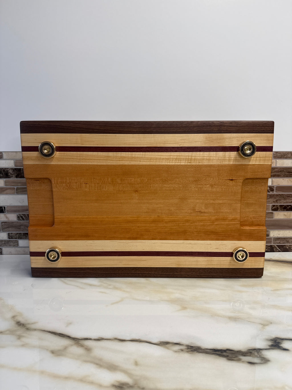Heritage Cutting Board 18” × 12” × 1.5” — Maple, Walnut, Cherry & Purple Heart | Juice Groove + Hand Holds with brass feet