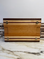 Heritage Cutting Board 18” × 12” × 1.5” — Maple, Walnut, Cherry & Purple Heart | Juice Groove + Hand Holds with brass feet