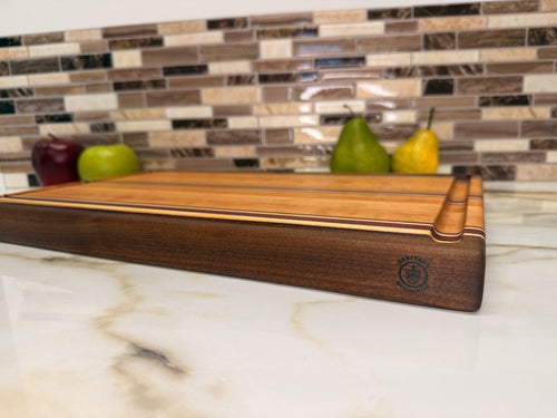 Heritage Cutting Board 18” × 12” × 1.5” — Maple, Walnut, Cherry & Purple Heart | Juice Groove + Hand Holds