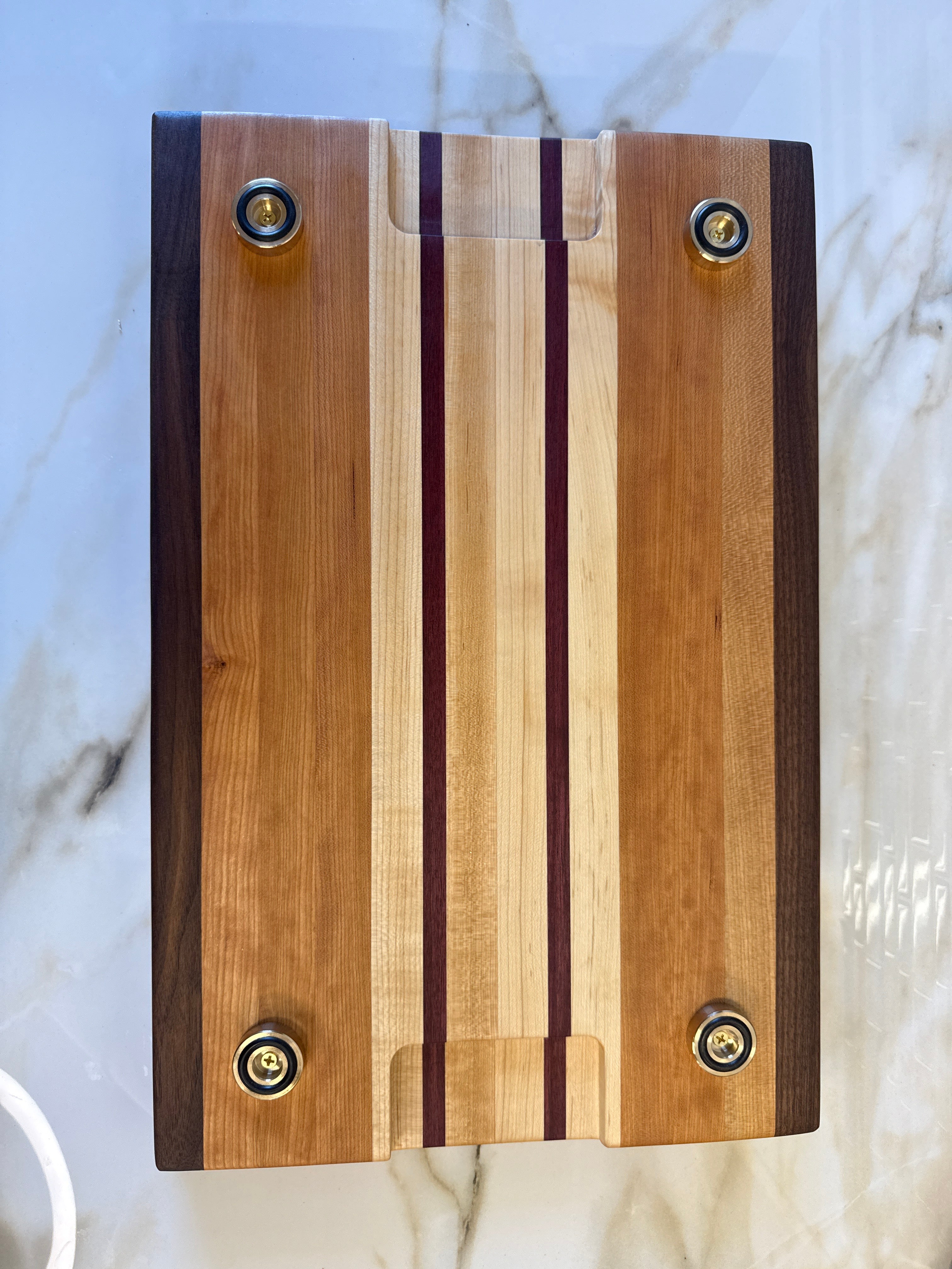 Heritage Cutting Board 18” × 12” × 1.5” — Maple, Walnut, Cherry & Purple Heart | Juice Groove + Hand Holds with brass feet