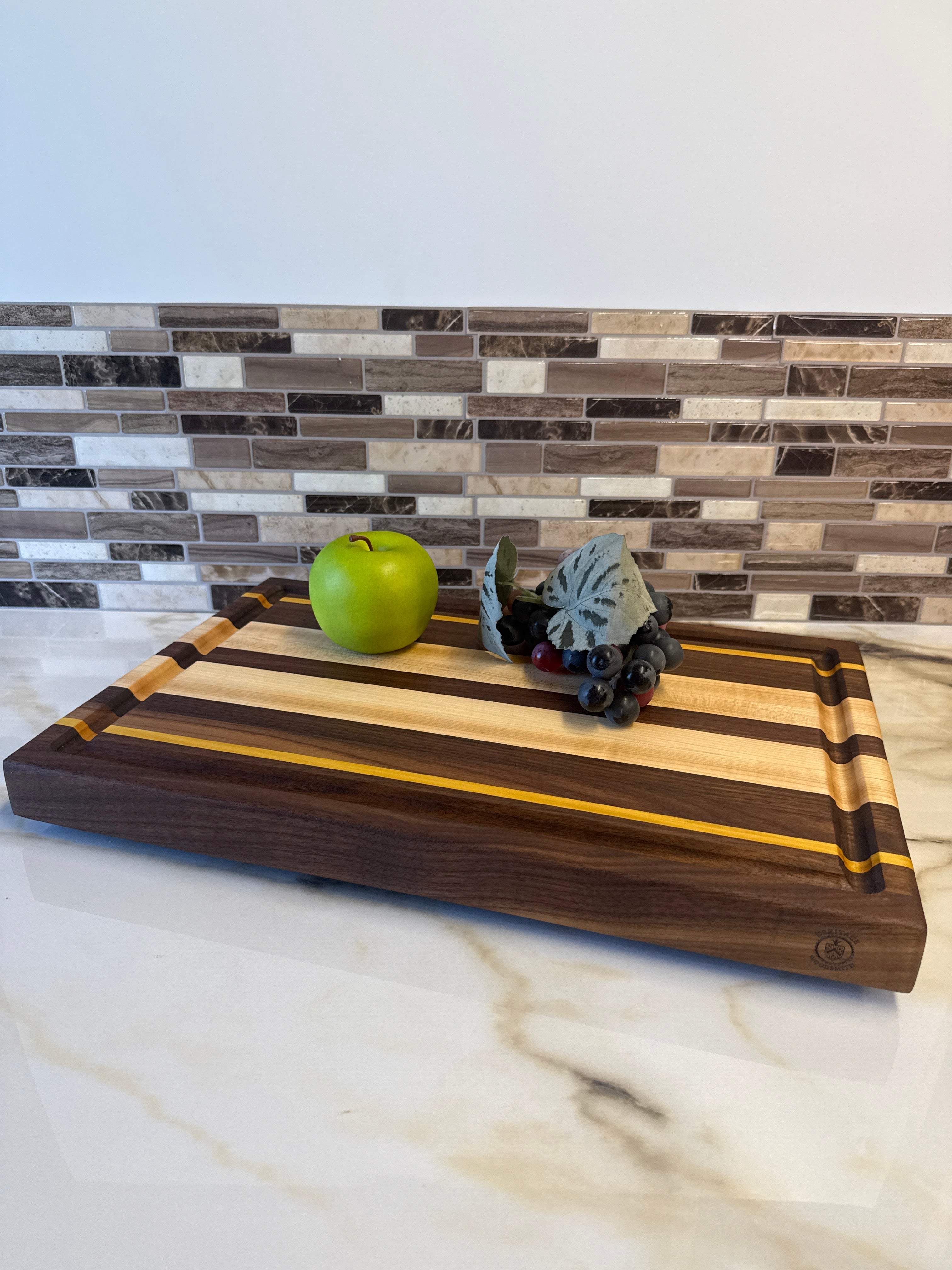 Heritage Cutting Board 18” × 12” × 1.5” — Maple, Walnut, & Yellow Heart | Juice Groove + Hand Holds with brass feet