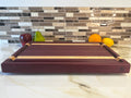 Heritage Cutting Board 18” × 12” × 1.5” — Purple Heart & Makple| Juice Groove + Hand Holds and Brass feet.